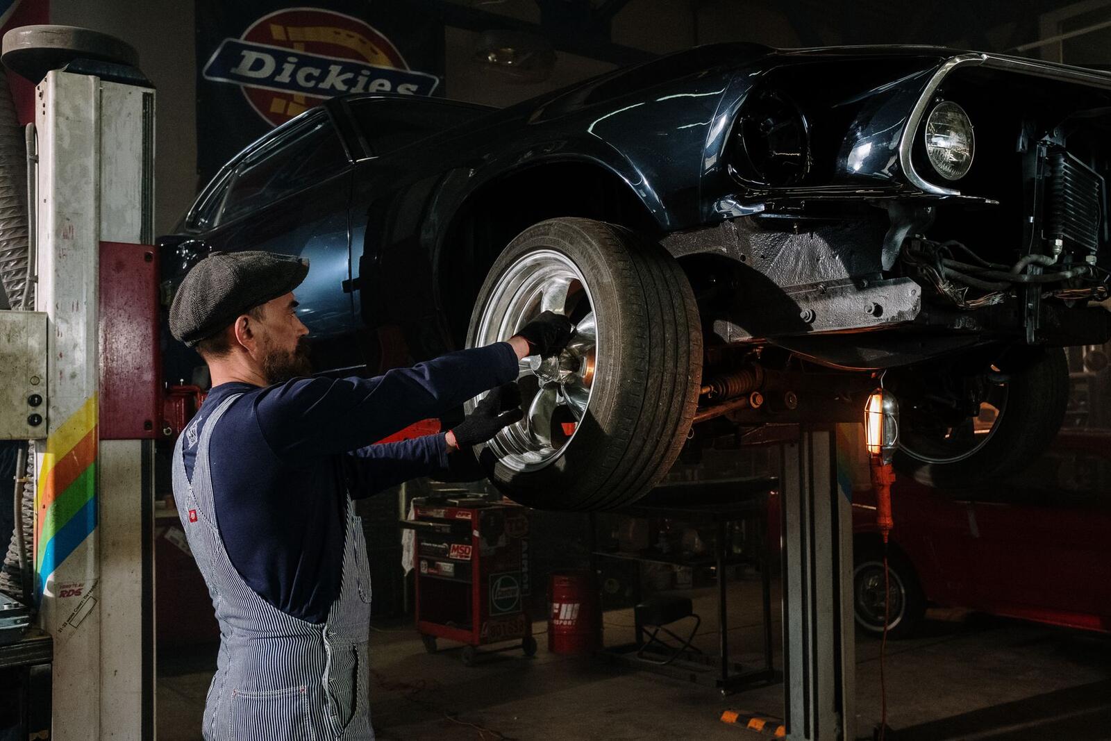 Technician working under a vehicle on a lift